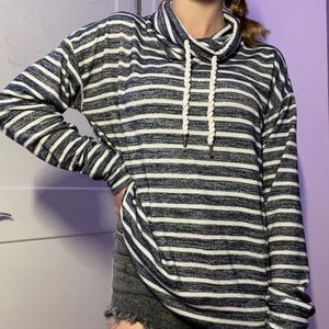 Striped long sleeve turtleneck with drawstring. Versatile for all seasons